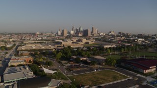DX0001_001033 - 5.7K aerial stock footage of flying over a community center to approach skyline of Downtown Kansas City, Missouri