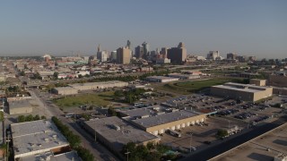 DX0001_001045 - 5.7K stock footage aerial video of approaching warehouse buildings, freeway and skyline of Downtown Kansas City, Missouri