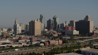DX0001_001056 - 5.7K aerial stock footage slow reverse view of freeway, office building and skyscrapers in Downtown Kansas City, Missouri