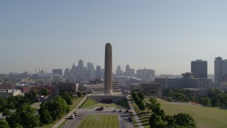 DX0001_001070 - 5.7K aerial stock footage ascend to approach the WWI memorial in Kansas City, Missouri, with a view of the downtown skyline