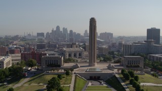 DX0001_001071 - 5.7K aerial stock footage ascend and fly toward the WWI memorial in Kansas City, Missouri, with a view of the downtown skyline