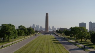 DX0001_001075 - 5.7K aerial stock footage ascend from green lawn toward the WWI memorial and skyline in Kansas City, Missouri