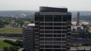 DX0001_001096 - 5.7K aerial stock footage of circling the top of a Crown Center office building in Kansas City, Missouri