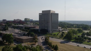 DX0001_001101 - 5.7K aerial stock footage fly away from a government office building and descend, Kansas City, Missouri