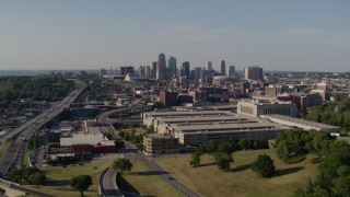 DX0001_001127 - 5.7K aerial stock footage reverse view of a government office building and city's skyline, Downtown Kansas City, Missouri