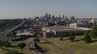 DX0001_001129 - 5.7K aerial stock footage ascend toward a government office building and city's skyline, Downtown Kansas City, Missouri