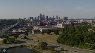 DX0001_001134 - 5.7K aerial stock footage descend near a government building and city's skyline, Downtown Kansas City, Missouri