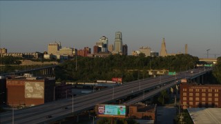 DX0001_001161 - 5.7K aerial stock footage of the city's skyline seen from freeway at sunset in Downtown Kansas City, Missouri