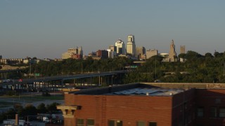 DX0001_001163 - 5.7K aerial stock footage of the city's skyline and freeway at sunset in Downtown Kansas City, Missouri