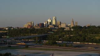 DX0001_001164 - 5.7K aerial stock footage of the city's skyline and freeway with light traffic at sunset in Downtown Kansas City, Missouri