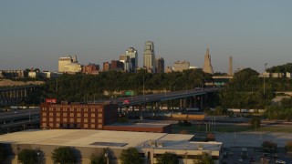 DX0001_001165 - 5.7K aerial stock footage flyby freeway with light traffic with view of skyline at sunset in Downtown Kansas City, Missouri