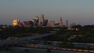 DX0001_001171 - 5.7K aerial stock footage of the setting sun reflecting off skyscrapers in Downtown Kansas City, Missouri