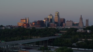 DX0001_001178 - 5.7K aerial stock footage of city high-rises reflecting the setting sun in Downtown Kansas City, Missouri, twilight