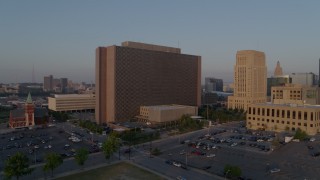 DX0001_001206 - 5.7K aerial stock footage a reverse view of a government building at sunrise, Downtown Kansas City, Missouri