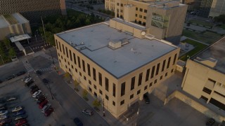 DX0001_001213 - 5.7K aerial stock footage of approaching police station at sunrise, Downtown Kansas City, Missouri