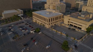 DX0001_001214 - 5.7K aerial stock footage fly away from police station at sunrise, reveal government office building, Downtown Kansas City, Missouri