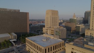 DX0001_001215 - 5.7K stock footage aerial video approach police station at sunrise, focus on courthouse, Downtown Kansas City, Missouri