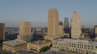 DX0001_001221 - 5.7K aerial stock footage orbit city hall and neighboring skyscraper at sunrise, Downtown Kansas City, Missouri