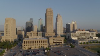 DX0001_001223 - 5.7K aerial stock footage passing city hall and neighboring skyscraper at sunrise, Downtown Kansas City, Missouri