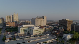 DX0001_001227 - 5.7K aerial stock footage reverse view of government offices, federal courthouse at sunrise, Downtown Kansas City, Missouri