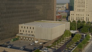 DX0001_001229 - 5.7K aerial stock footage of orbiting a government office building at sunrise, Downtown Kansas City, Missouri