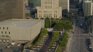 DX0001_001230 - 5.7K aerial stock footage orbit lower levels of a government office building at sunrise, Downtown Kansas City, Missouri