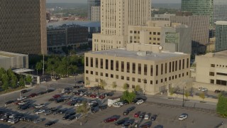 DX0001_001240 - 5.7K aerial stock footage fly away from the downtown police station at sunrise, Downtown Kansas City, Missouri