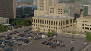 DX0001_001241 - 5.7K aerial stock footage of passing the downtown police station at sunrise, Downtown Kansas City, Missouri