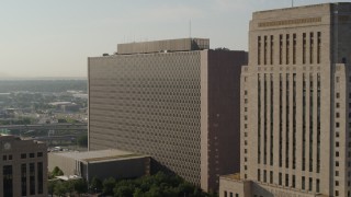 DX0001_001250 - 5.7K aerial stock footage of approaching a government office building at sunrise, Downtown Kansas City, Missouri