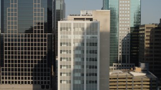 DX0001_001253 - 5.7K aerial stock footage of orbiting a downtown office building at sunrise, Downtown Kansas City, Missouri