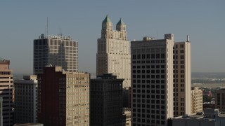 DX0001_001255 - 5.7K aerial stock footage of a slow approach to a tall skyscraper at sunrise, Downtown Kansas City, Missouri