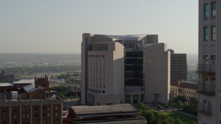 DX0001_001257 - 5.7K aerial stock footage flyby a tall skyscraper to reveal the federal courthouse at sunrise, Downtown Kansas City, Missouri