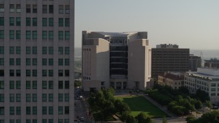 DX0001_001258 - 5.7K aerial stock footage flyby the federal courthouse for closer view of skyscraper at sunrise, Downtown Kansas City, Missouri