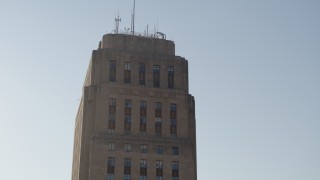 DX0001_001260 - 5.7K aerial stock footage orbit and tilt down the side of city hall at sunrise, Downtown Kansas City, Missouri