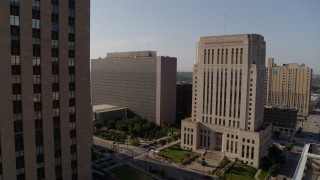 DX0001_001261 - 5.7K aerial stock footage of government office building beside a courthouse at sunrise, Downtown Kansas City, Missouri