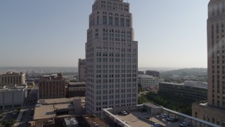 DX0001_001272 - 5.7K aerial stock footage of approaching a city skyscraper at sunrise, Downtown Kansas City, Missouri