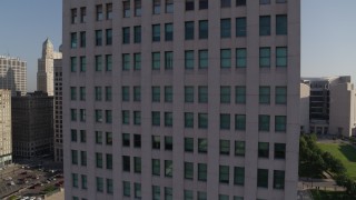 DX0001_001273 - 5.7K aerial stock footage of reverse view of a city skyscraper at sunrise, Downtown Kansas City, Missouri