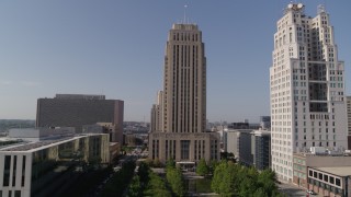 DX0001_001286 - 5.7K aerial stock footage of city hall near a tall skyscraper in Downtown Kansas City, Missouri