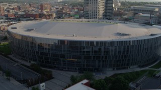 DX0001_001344 - 5.7K aerial stock footage of a close orbit of an arena at sunset in Downtown Kansas City, Missouri