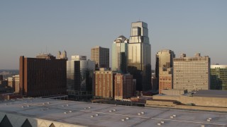 DX0001_001348 - 5.7K aerial stock footage of the setting sun shining on downtown skyscrapers in Downtown Kansas City, Missouri