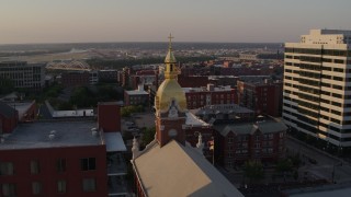 DX0001_001351 - 5.7K aerial stock footage fly away from brick cathedral and office building at sunset in Downtown Kansas City, Missouri