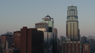 DX0001_001354 - 5.7K aerial stock footage of light reflecting off of skyscrapers at sunset in Downtown Kansas City, Missouri