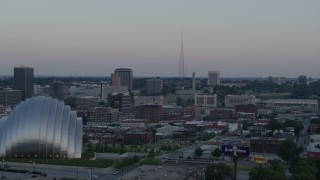 DX0001_001359 - 5.7K aerial stock footage of radio tower, fly past the convention center and concert hall at sunset in Downtown Kansas City, Missouri