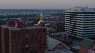 DX0001_001360 - 5.7K aerial stock footage of orbiting a cathedral's steeple at sunset in Downtown Kansas City, Missouri