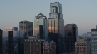 DX0001_001363 - 5.7K aerial stock footage ascend and orbit tall city skyscrapers at sunset in Downtown Kansas City, Missouri