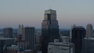 DX0001_001364 - 5.7K aerial stock footage descend and orbit tall city skyscrapers at sunset in Downtown Kansas City, Missouri