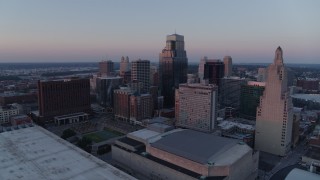 DX0001_001367 - 5.7K aerial stock footage flyby tall city skyscrapers at sunset and descend in Downtown Kansas City, Missouri