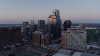 DX0001_001375 - 5.7K aerial stock footage passing by a group of skyscrapers at twilight in Downtown Kansas City, Missouri