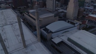 DX0001_001378 - 5.7K aerial stock footage tilt from convention center for view of skyscrapers at twilight in Downtown Kansas City, Missouri
