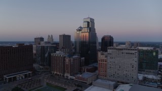 DX0001_001379 - 5.7K aerial stock footage of flying by a group of skyscrapers at twilight in Downtown Kansas City, Missouri